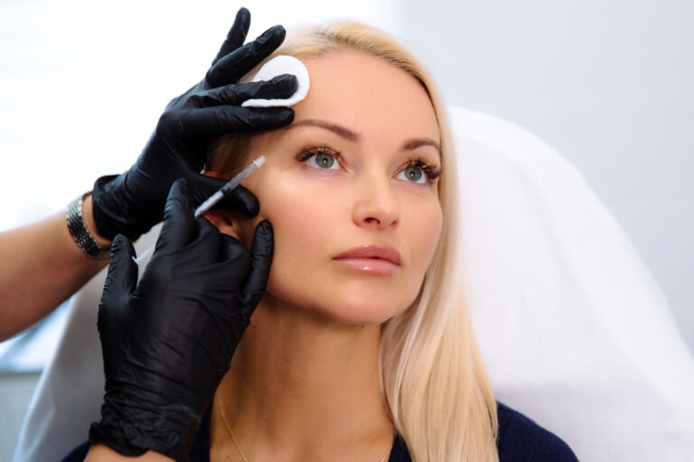Med spa provider administering a Botox or Dysport injection around the outer eye to soften crow’s feet lines