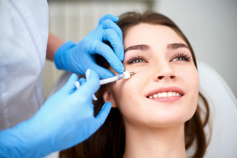 Close-up of a woman receiving under eye filler injections to reduce dark circles.