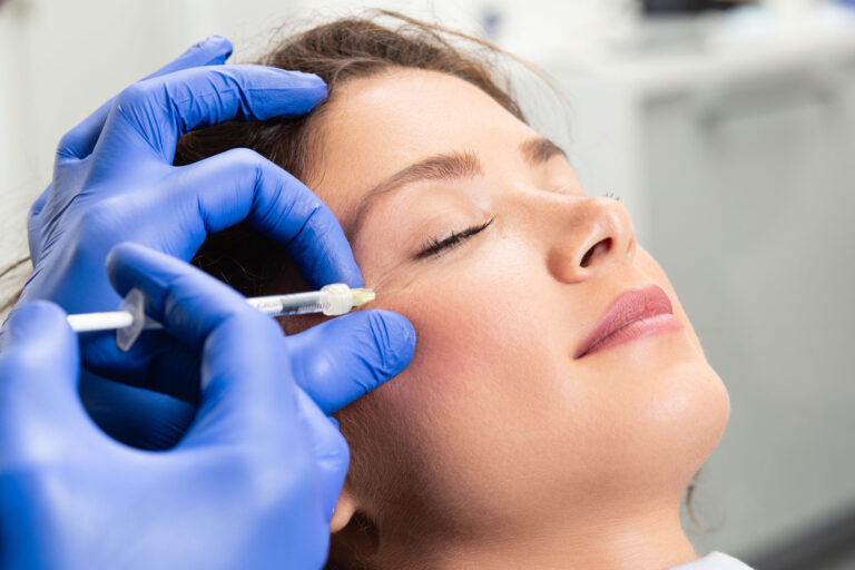 Cosmetic provider performing neuromodulator injection near eye area illustrating xeomin vs botox wrinkle treatment.