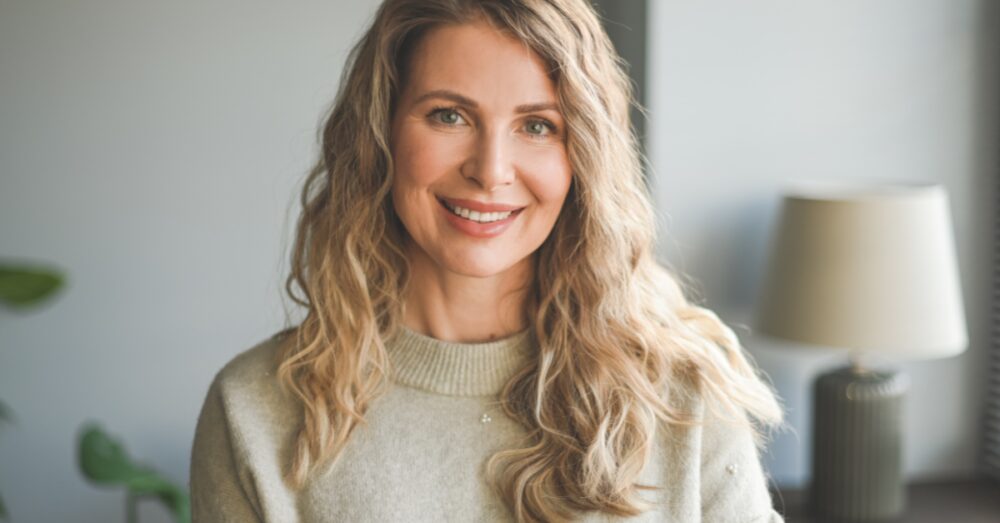 Happy woman with healthy glowing skin feeling balanced and refreshed