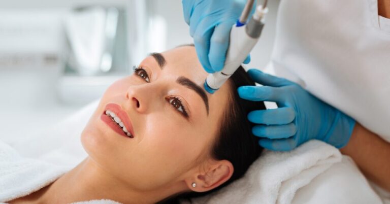 Woman receiving a HydraFacial treatment with a handheld device