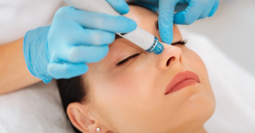 Female with eyes closed during a HydraFacial session